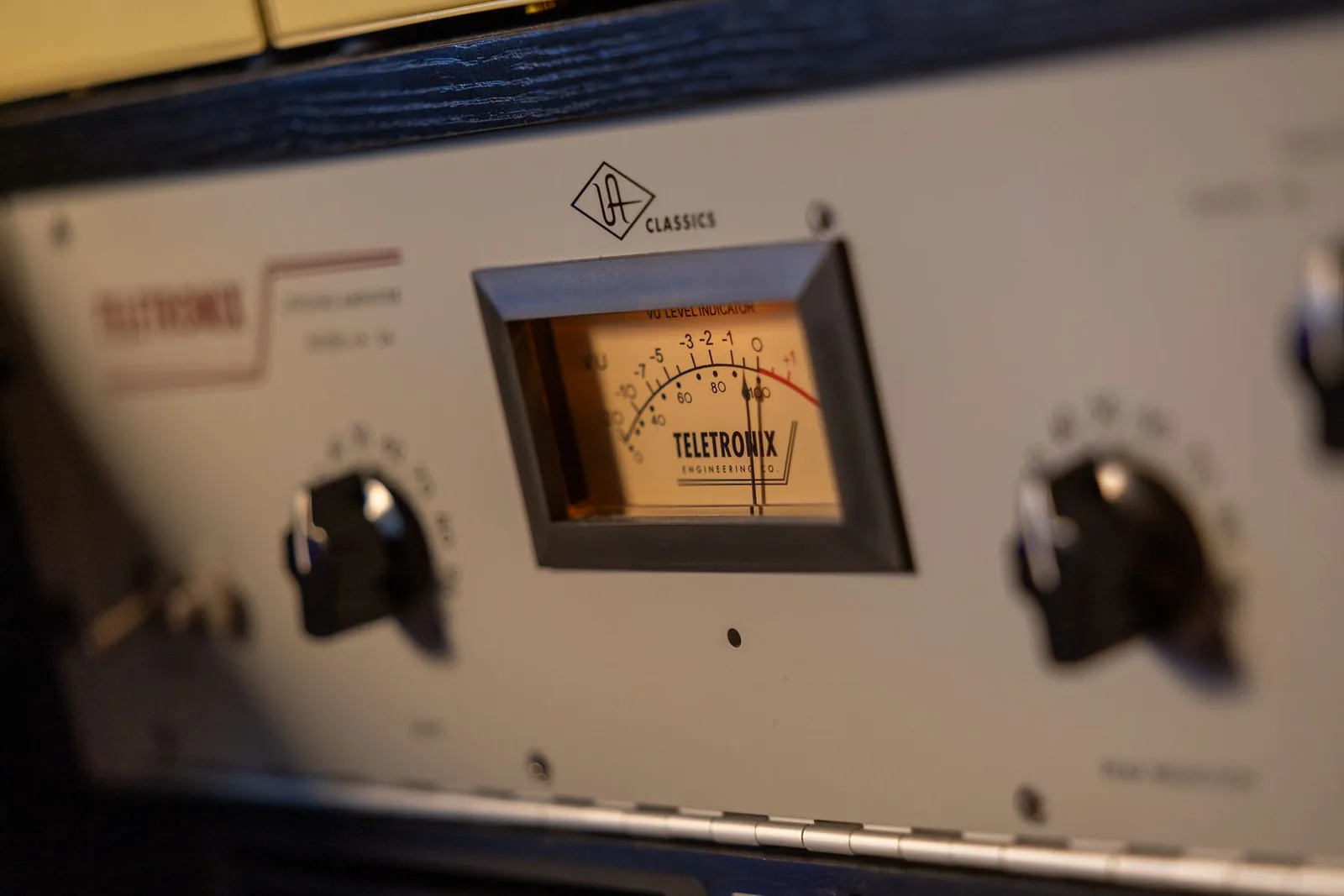 Photo of a Teletronix LA-2A hardware optical compressor unit with its two-knob front panel showing Peak Reduction and Gain controls.